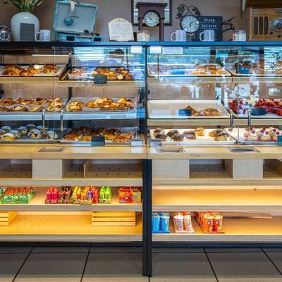 Display cases and shelves with groceries.