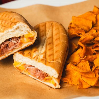 Grilled cheese sandwich with chips, close up.