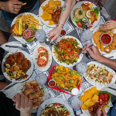 A vibrant gathering around a table laden with various dishes.