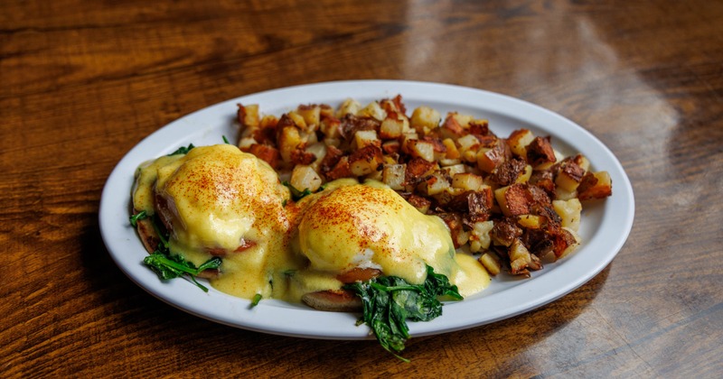 Eggs Benedict served with home fries