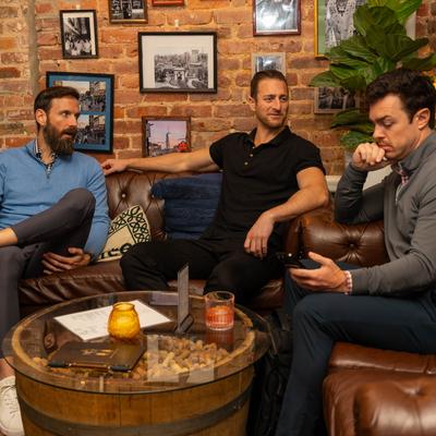 Interior, three friends having drinks at the table.