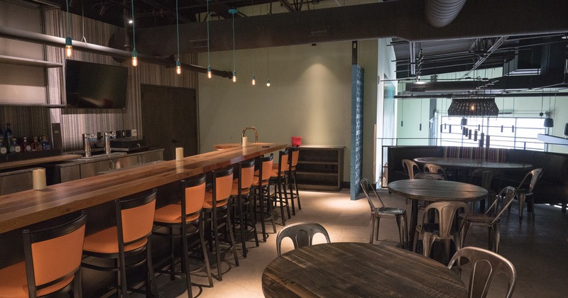 Industrial style dining area and bar on the first floor