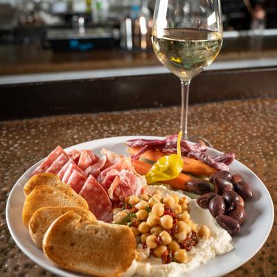 Antipasto platter, white wine in the glass