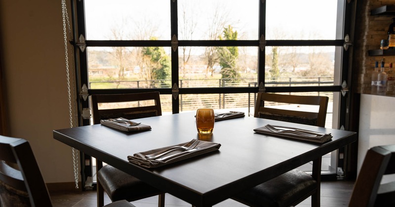 Inside, seating area with table and chairs near window