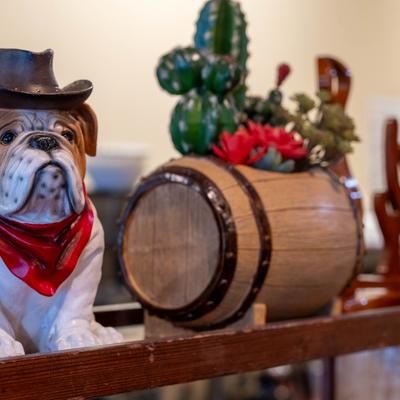Cowboy Bulldog resin figurine displayed alongside barrel-style planter.