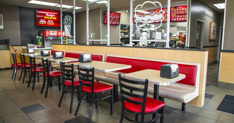 Interior with tables, chairs and menu boards.