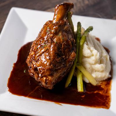 Beef short rib with a side of mashed potatoes.