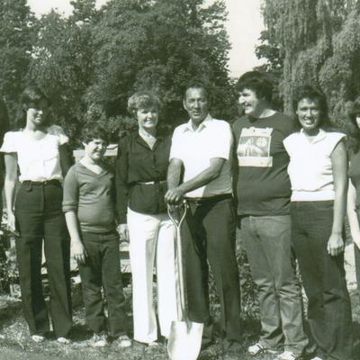 Retro black and white picture of a multigenerational family standing outdoors.