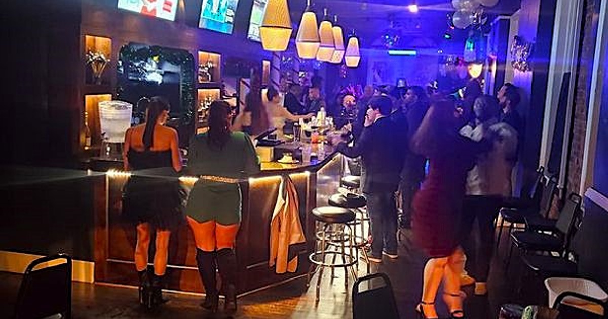 A lively bar scene with people socializing and dancing