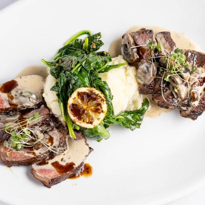 Sliced steak in creamy sauce, served with sauteed spinach and mashed potatoes.