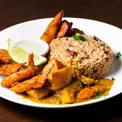 Coconut curry chicken, fried shrimp, rice, and fried plantains.