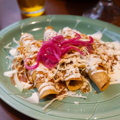 Crispy chicken tacos with Honduran slaw, cheese and pickled onions.