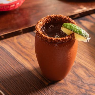 Paloma cocktail in a clay cup.