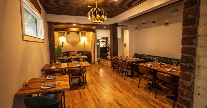 Interior, dining area, wooden top tables with chairsready for guests, wooden flooring