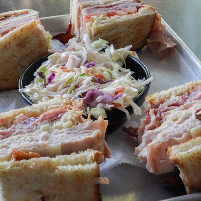 Turkey club sandwiches and coleslaw.