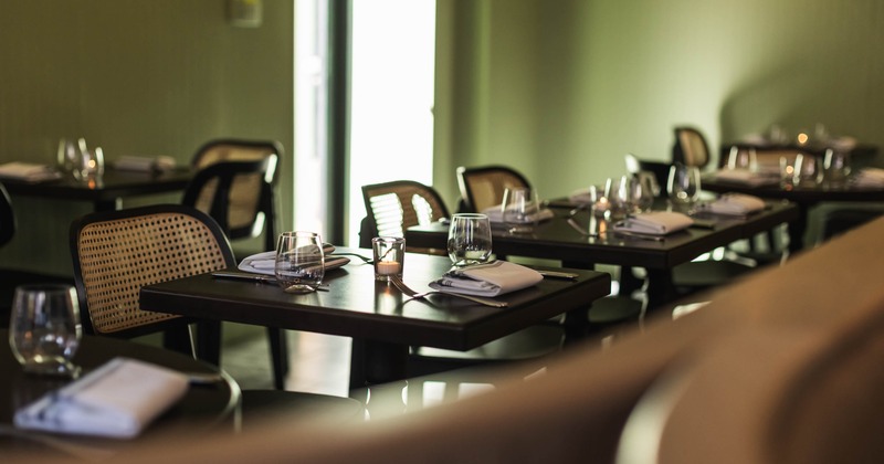 Interior, dining area, wooden top tables for two people