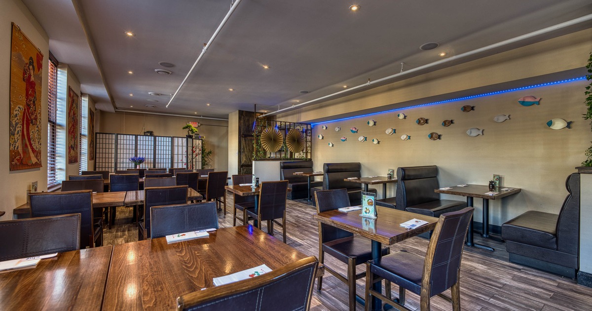Modern restaurant interior with dark wood tables and chairs