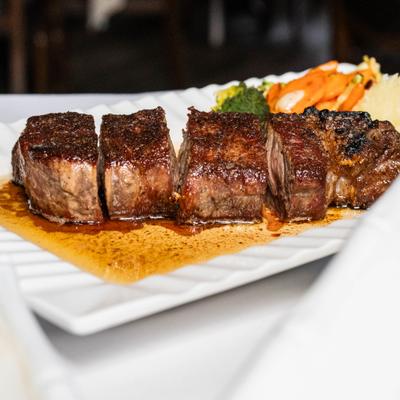 Dry aged ribeye steak, with herb butter, mashed potatoes, and veggies.
