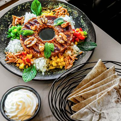 Kibbeh nayeh platter, pita and a creamy whit dip.