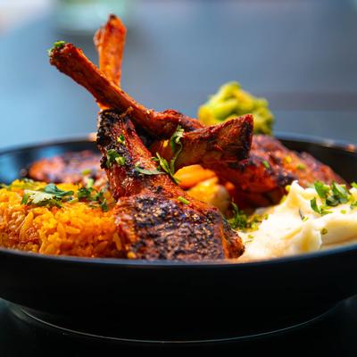 Lamb chops, with mashed potatoes, fried rice, and sauteed veggies.