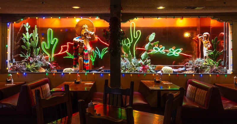 Interior, dining area, booths with tables, various decoration with neon signage