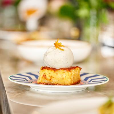 Greek orange cake with a scoop of ice cream on top.