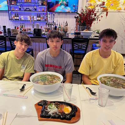Three customers with large soup bowls.