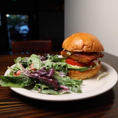 Blackened Salmon Sandwich with side salad.
