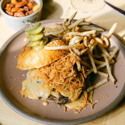 Chop Shop Cheeseburger and fries. Cheesy, messy, oniony. At the bar at Table Asheville..