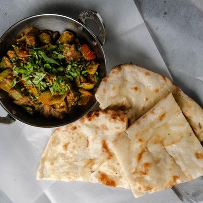 Okra cooked with spices and tomatoes, served with naan bread.