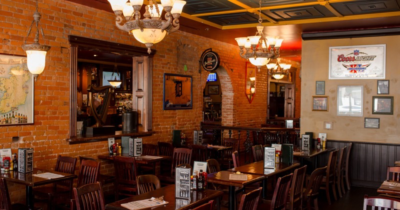 Interior, dining area with large mirror on the wall, chandeliers
