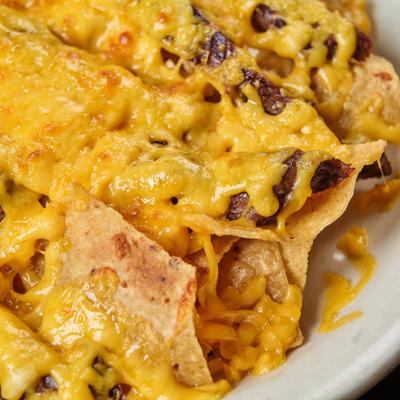 Beef Fajita Nachos topped with melted cheese, close-up.