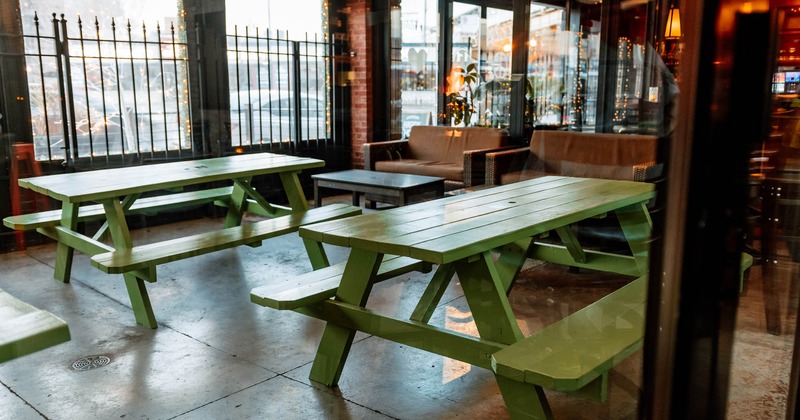Green wooden table with bench seating