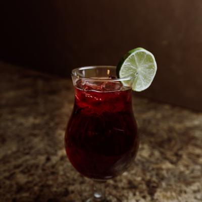 Glass of Sangria garnished with a lime wheel.
