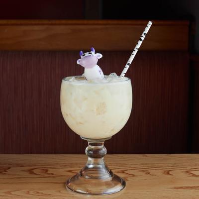 Cocktail on the rocks, with a cow figurine.