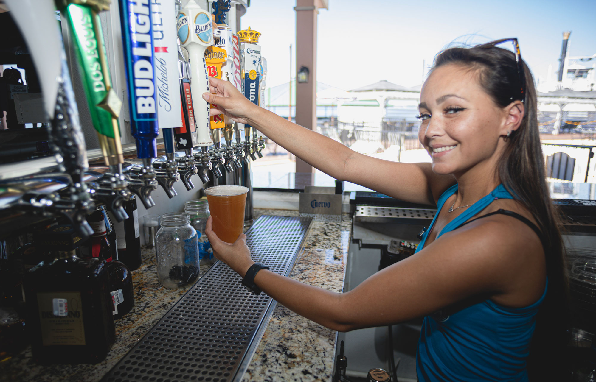 An employee pouring beer