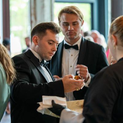 Guests enjoying appetizing food at an event.