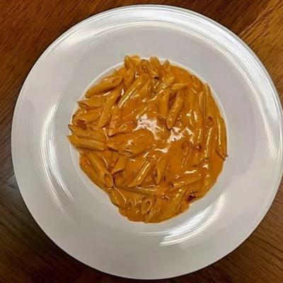 Penne pasta in pink vodka sauce.
