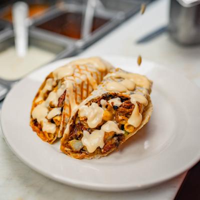 Burrito with BBQ ribs, sausage, mac and cheese, potato, and jalapeno.