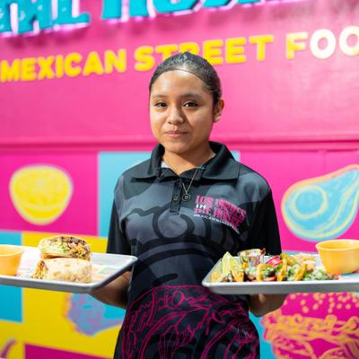 Server holding plates of food.