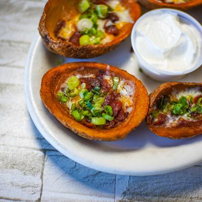 Loaded potato skins with dipping sauce.
