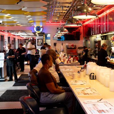 Customers sitting at the bar tables.