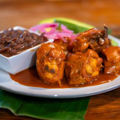Chicken with beans, avocado slices, and pickled red onion.