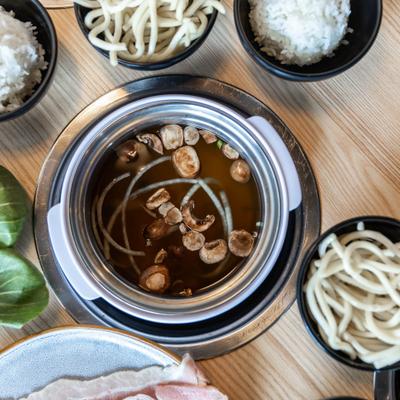 Broth with mushroom with a noodle side.