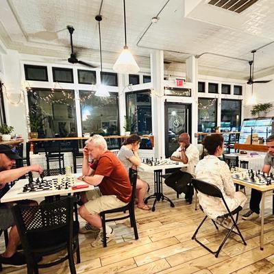 People playing chess in a cafe.