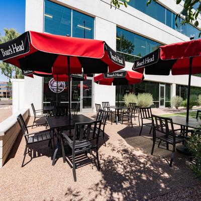 Exterior, outdoor seating area, tables and chairs with parasols.