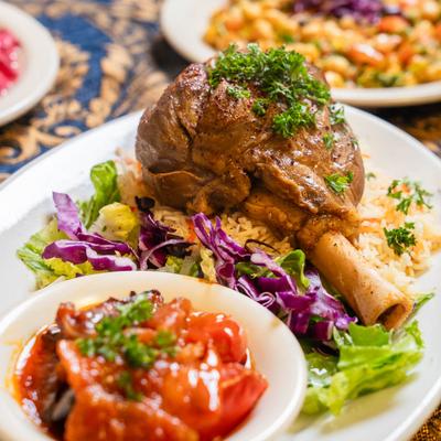 Slow-cooked lamb shank served with basmati rice and eggplant stew.
