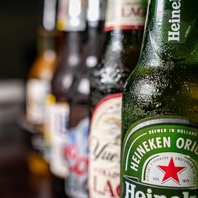Aligned bottles of assorted beers.
