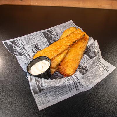 Zucchini planks served with a dipping sauce.