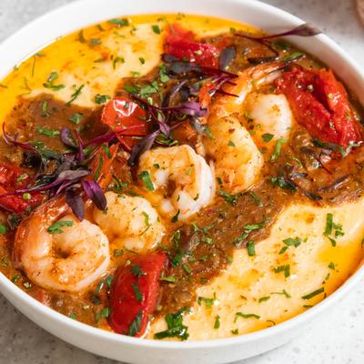 Shrimp and grits with chicken sausage, tomatoes, and cheddar grits.